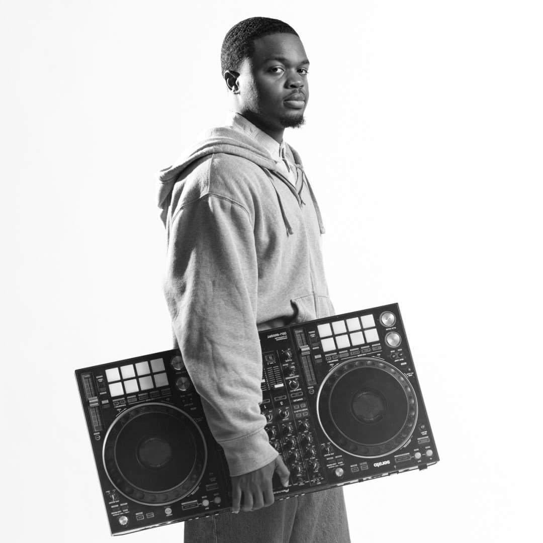 DJ Vic holding his DJ controller